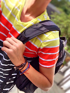 person holding black backpack thumbnail