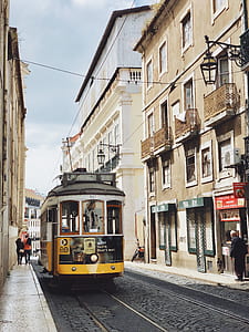 white and yellow tram near building thumbnail