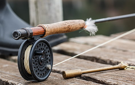 brown fishing rod with black reel thumbnail