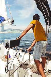 person holding motorboat steering wheel looking at the body of water thumbnail