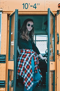 woman standing beside door inside vehicle thumbnail
