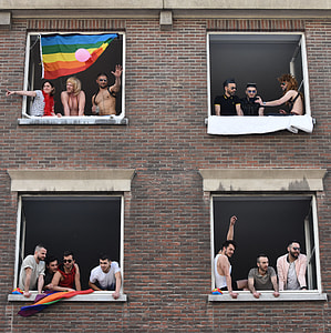 group of people on windows with white wooden frames thumbnail