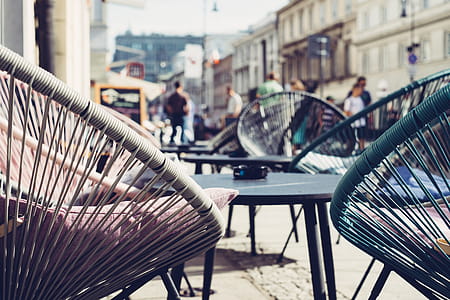 Selective Focus Photography of Patio Set Near Walking People thumbnail