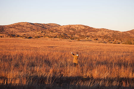 person on brown grass field during daytime thumbnail
