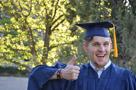 man in mortarboard and academic dress showing thumbs up sign thumbnail
