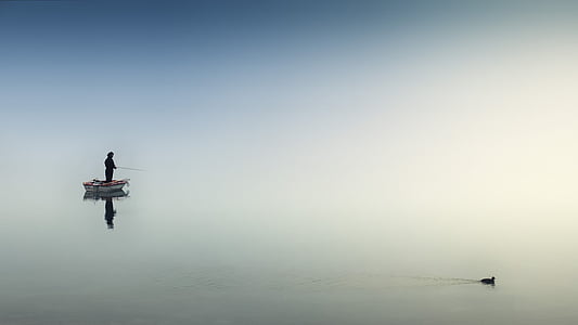 man fishing in boat during daytime thumbnail