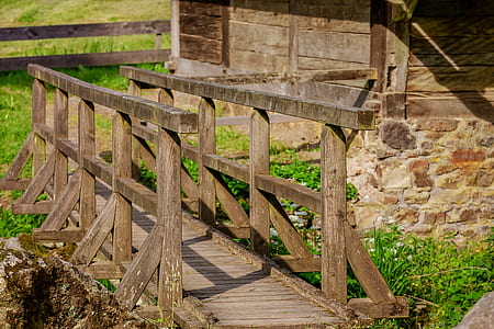 mini brown wooden bridge surrounded by green grass at daytime thumbnail