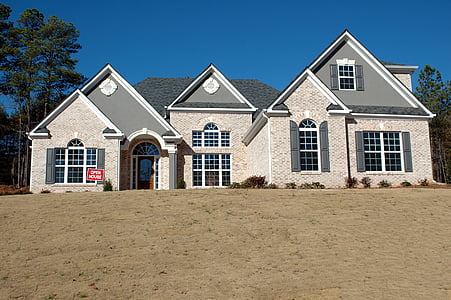 gray and beige concrete house under blue clear sky during daytime thumbnail