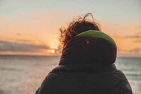 person's back facing body of water thumbnail