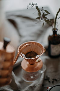 closeup photo of teapot pouring water on tea funnel thumbnail