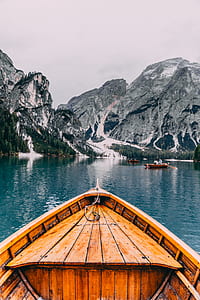 person using brown wooden boat thumbnail