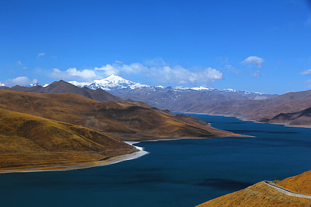body of water surrounded with mountains thumbnail