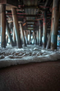 sea foam under wooden docks thumbnail