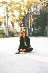 woman sitting on gray pavement thumbnail