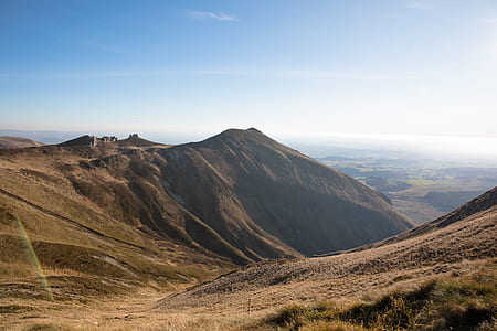 brown mountain under white cloud blue skies thumbnail