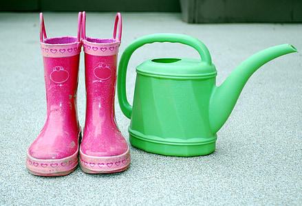 pair of pink rainboots and green pitcher thumbnail
