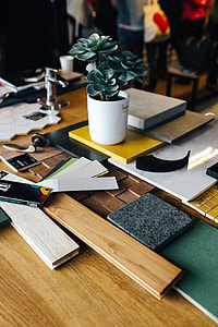 Designers working with material samples and paper cutouts thumbnail