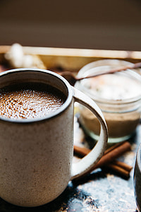 brown ceramic mug on black table thumbnail