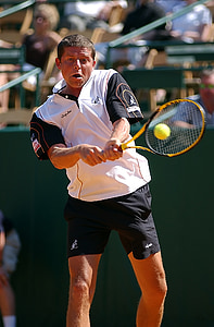 man playing tennis during daytime thumbnail