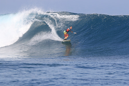 man surfing on ocean waves during daytime thumbnail
