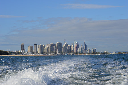 gray concrete buildings near body of water under blue sky during daytime thumbnail