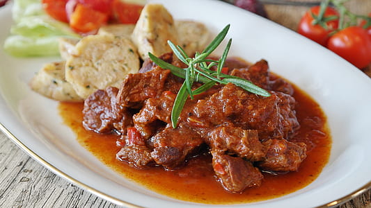 selective focus photography of stew with vegetables on white plate thumbnail