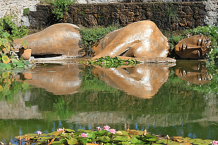 brown rocks near body of water photo thumbnail