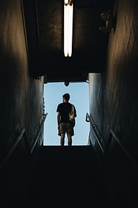man standing on top of stairs thumbnail