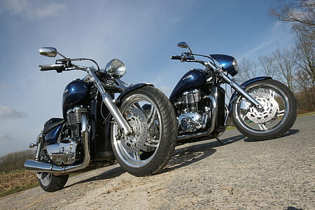 two black cruiser motorcycle parking near tree thumbnail