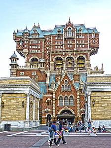 people in front of brown building thumbnail