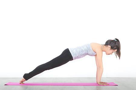 woman wearing gray spaghetti strap doing yoga gesture thumbnail
