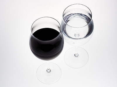 two water goblets filled with water and black liquid thumbnail