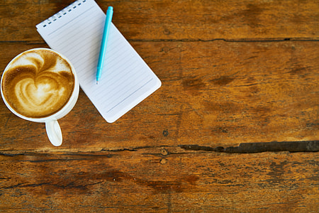 cup of espresso beside ruled paper and ballpoint pen thumbnail