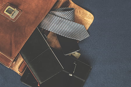 black long wallet on black leather tablet case beside gray necktie thumbnail