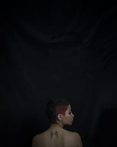 topless woman showing her back with angel wings tattoo thumbnail