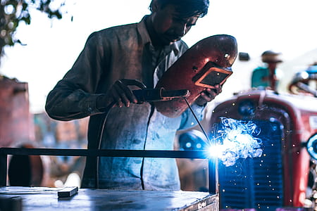 person welding metal parts at daytime thumbnail