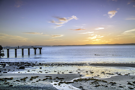 gray dock under golden sky thumbnail