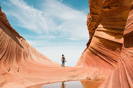 man standing on brown rock mountain during daytime thumbnail