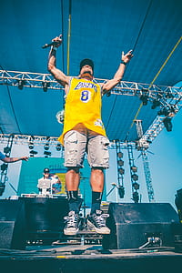 man playing on stage jumping thumbnail