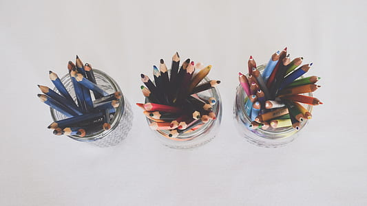 three clear glass canister filled with colored pencils thumbnail