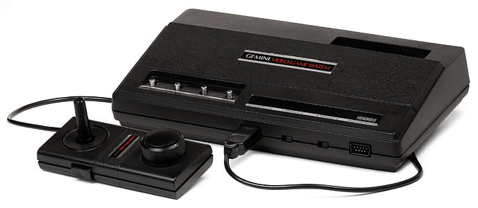 black Atari game console with controller thumbnail