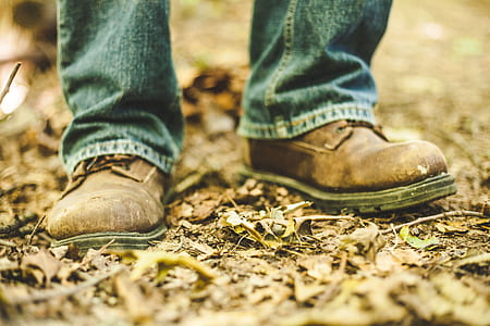 closeup photo of man wearing brown leather shoes and blue jeans thumbnail