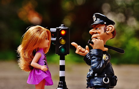 toy traffic light beside toy police man thumbnail