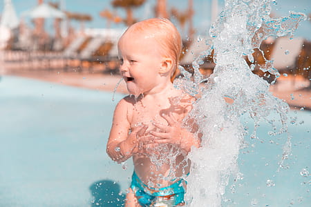 time lapse photography of water splashing on toddler thumbnail