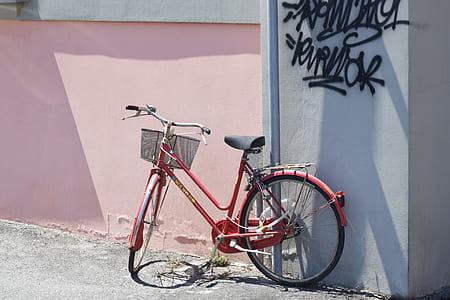 red commuter bike lean on wall thumbnail
