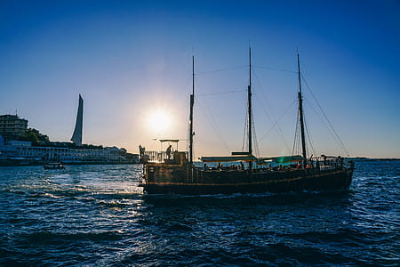 Green and Black Boat on Body of Water during Sunrise thumbnail