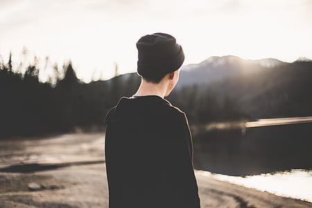 man standing near body of water thumbnail