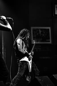 greyscale photo of band playing on stage thumbnail