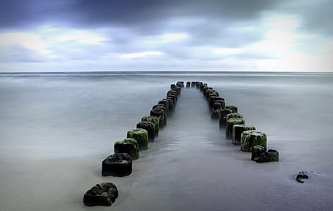 time lapse photo of shore line and stones thumbnail