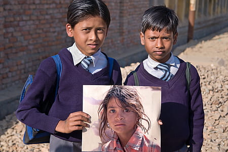 boy in purple sweater holding photo of a girl thumbnail